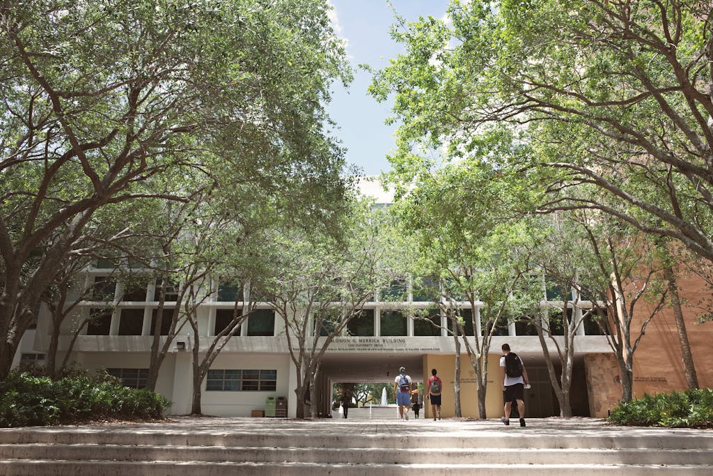 University campus in Coral Gables, Florida, with students walking under a sunny sky.