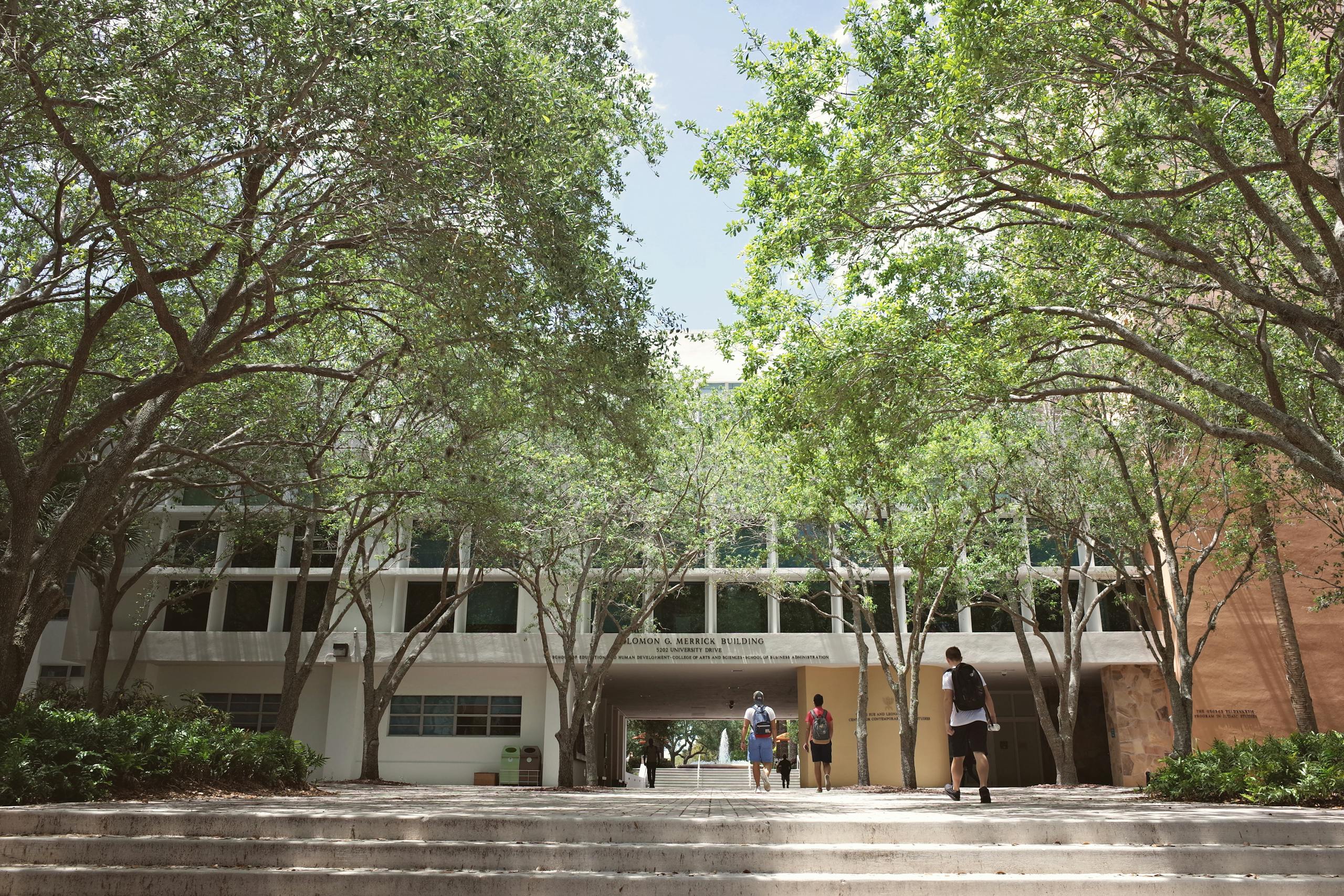 University campus in Coral Gables, Florida, with students walking under a sunny sky.